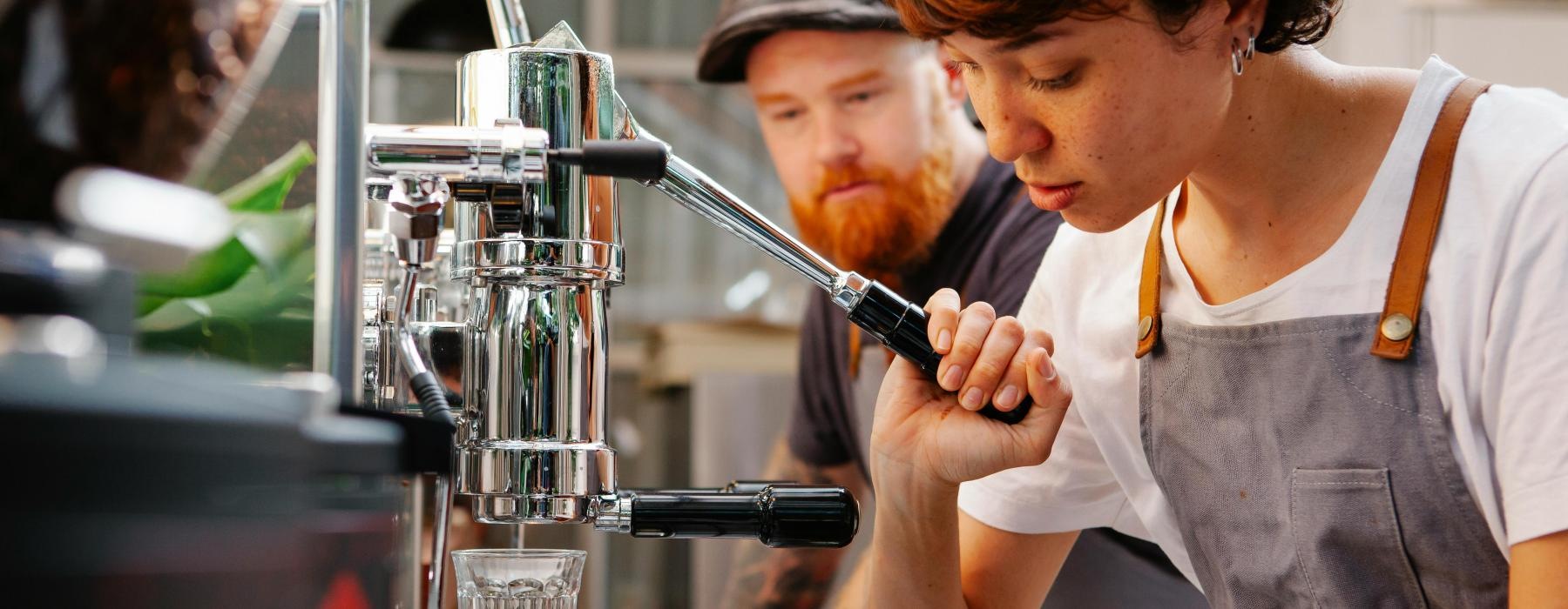 a man and woman working at a coffee shop