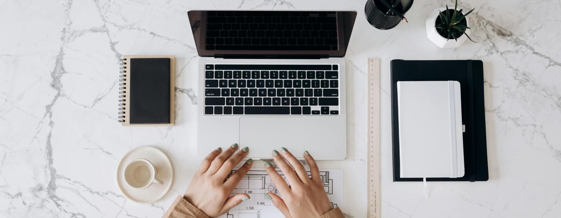 Person sitting at a table working on her computer